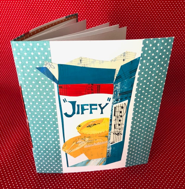 photo of handmade book with a collage of a Jiffy corn muffin mix on the cover