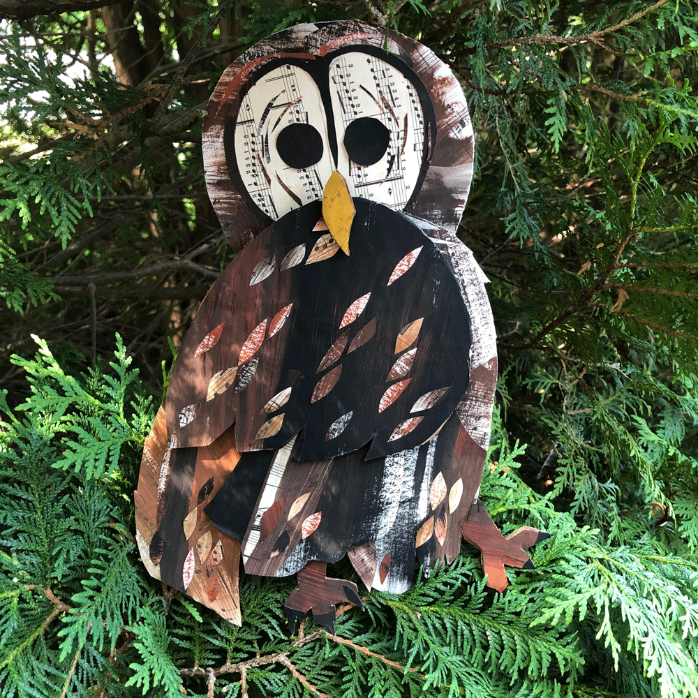 Barred owl collage on cardboard sitting in a pine tree