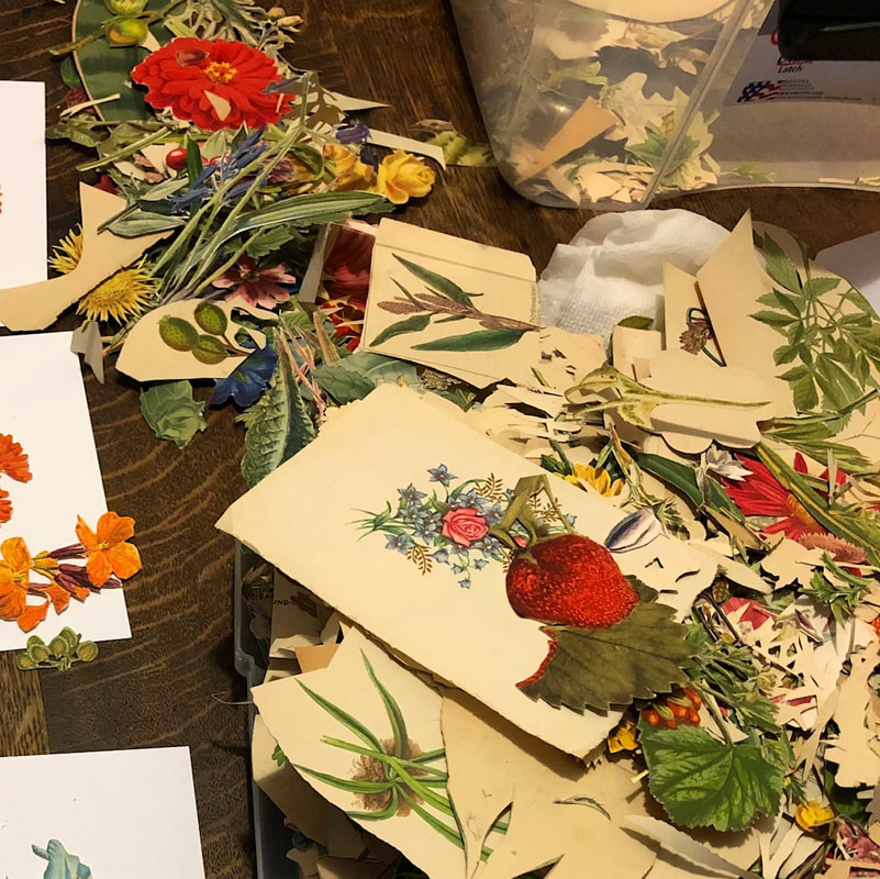 A collection of vintage floral papers for collage, cut up in a pile