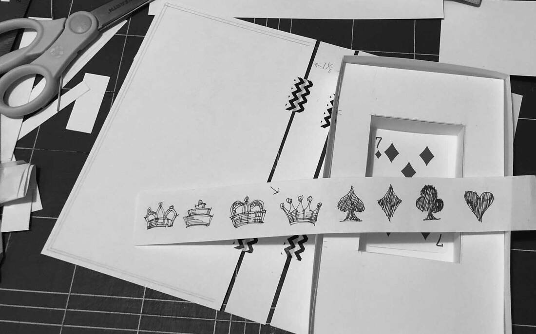 Black and white test box with 7 of diamonds card and sketch of card icons