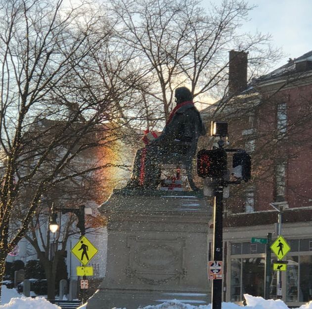 Longfellow statue with rainbow