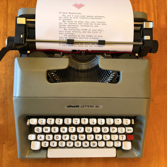 Sheet of paper in typewriter with typed poem, 